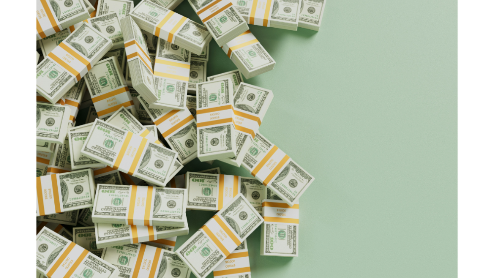 Stacks of bundled U.S. one hundred dollar bills arranged across a light green background, representing wealth or financial success.
